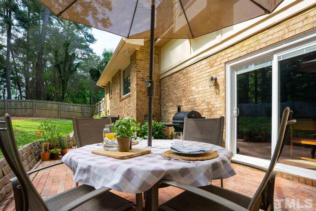 4208 Pickwick Drive Raleigh, NC 27613 - Photo 23 of 25 a view of a patio with table and chairs and potted plants