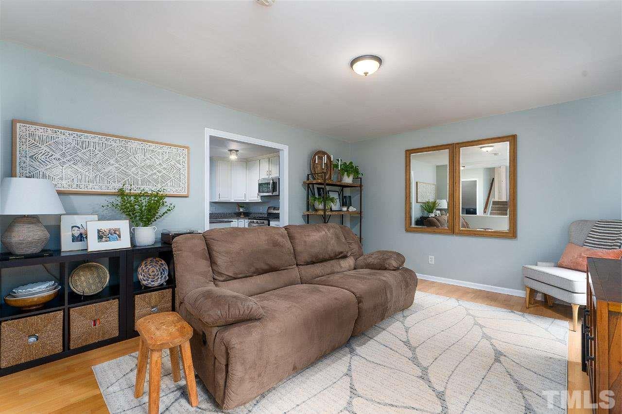 4208 Pickwick Drive Raleigh, NC 27613 - Photo 4 of 25 a living room with furniture a lamp and a window