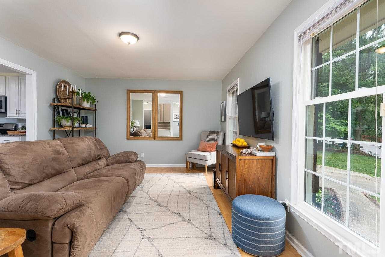 4208 Pickwick Drive Raleigh, NC 27613 - Photo 5 of 25 a living room with furniture and a flat screen tv