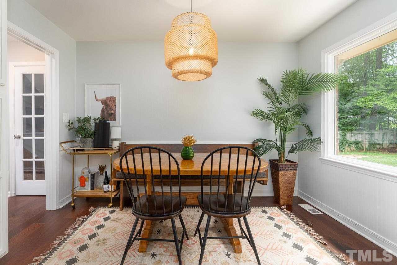 4208 Pickwick Drive Raleigh, NC 27613 - Photo 9 of 25 a view of a dining room with furniture window and wooden floor