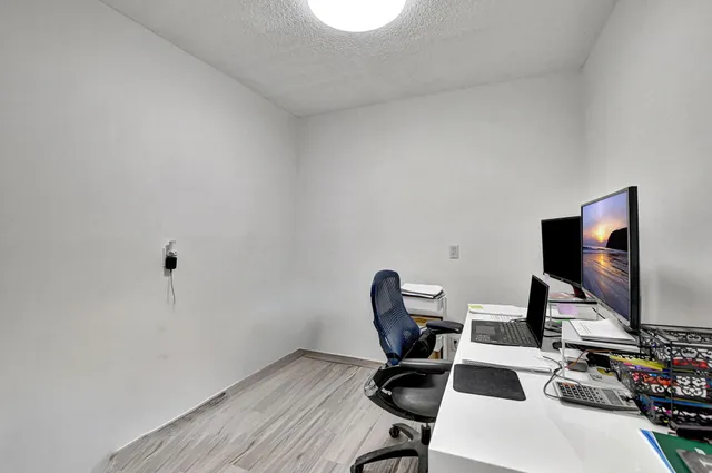 a workspace with furniture and a flat screen tv