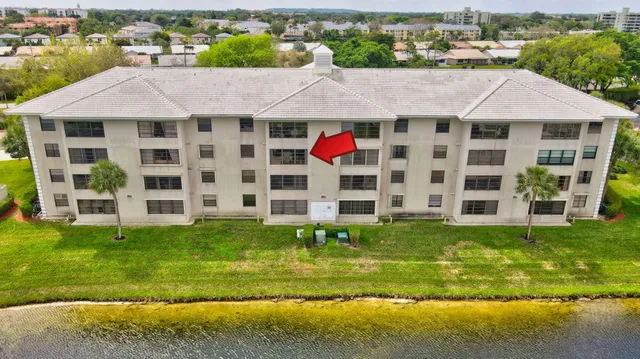 a aerial view of a house with a yard table and chairs