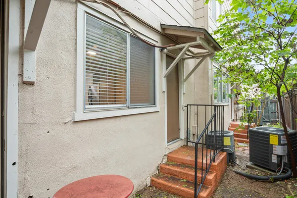 a view of a balcony with chairs and wooden fence