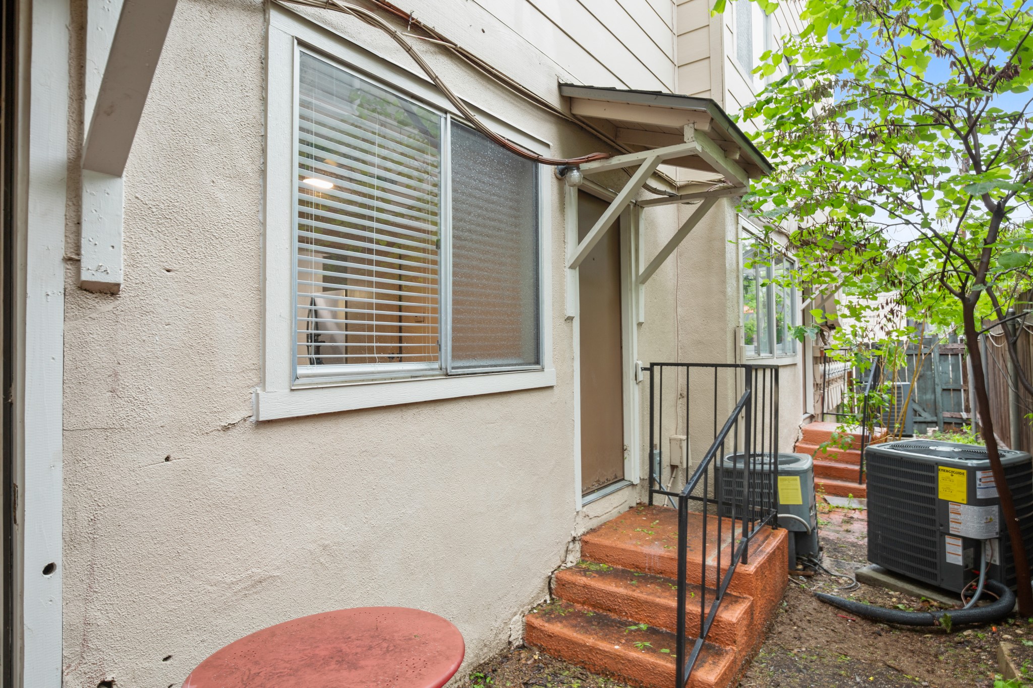 1010 West 23rd Street, Unit 3 Austin, TX 78705 - Photo 12 of 15 a view of a balcony with chairs and wooden fence
