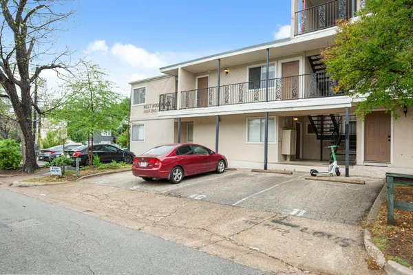 a front view of a house with parking yard and outdoor seating