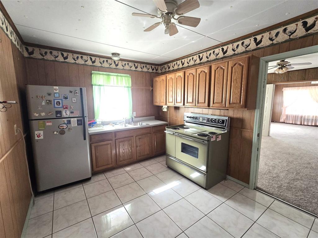 3101 Medulla Road Plant City, FL 33566 - Photo 19 of 83 a kitchen with a stove a sink and a refrigerator