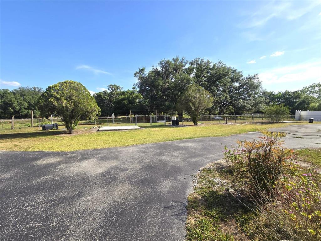 3101 Medulla Road Plant City, FL 33566 - Photo 40 of 83 a view of a swimming pool with an outdoor space and seating area
