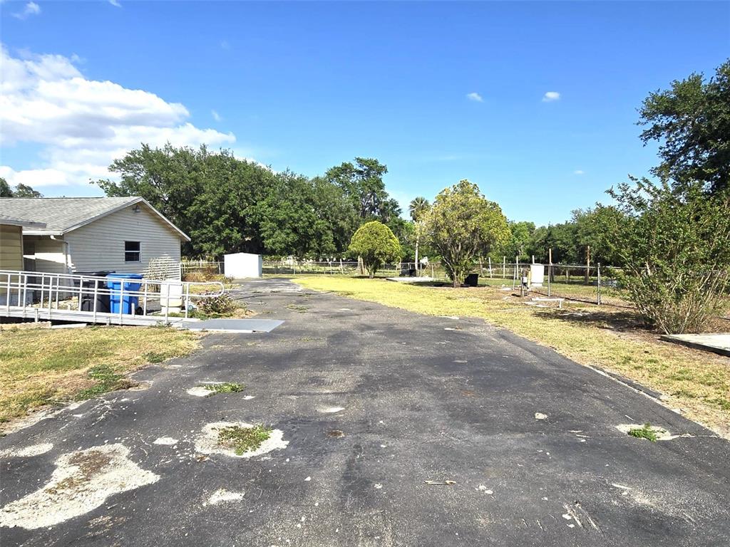 3101 Medulla Road Plant City, FL 33566 - Photo 44 of 83 a view of swimming pool with a yard and trees in the background