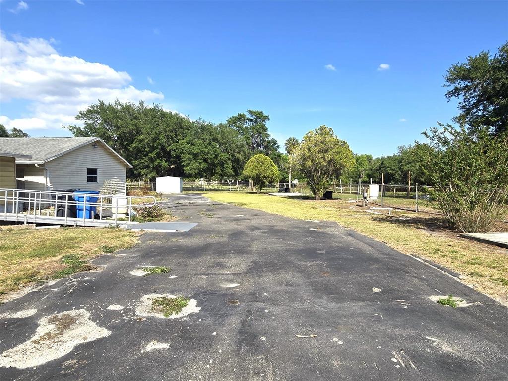 3101 Medulla Road Plant City, FL 33566 - Photo 48 of 83 a view of swimming pool with a yard and trees in the background