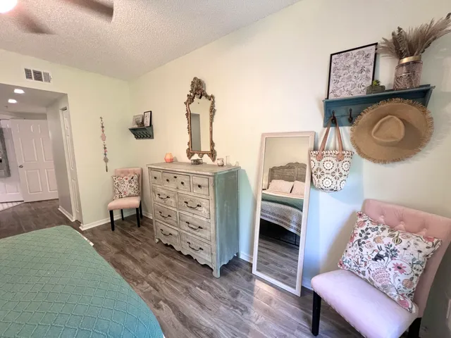 a bedroom with furniture and a wooden floor
