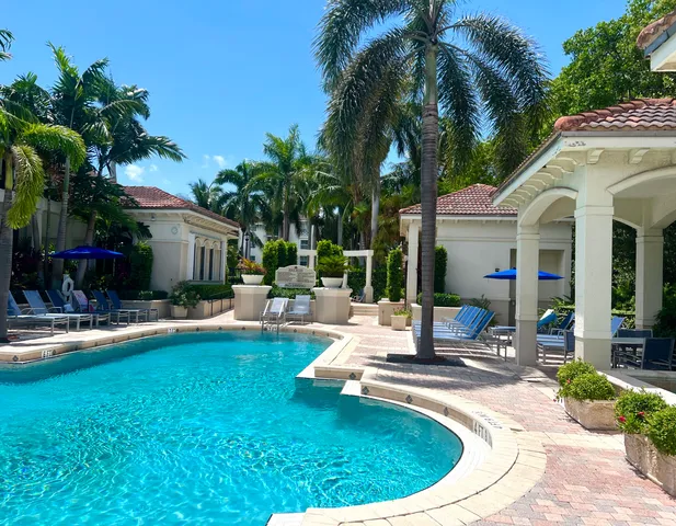 a view of a house with swimming pool and sitting area