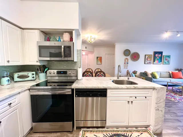a kitchen with stainless steel appliances granite countertop a stove and a microwave
