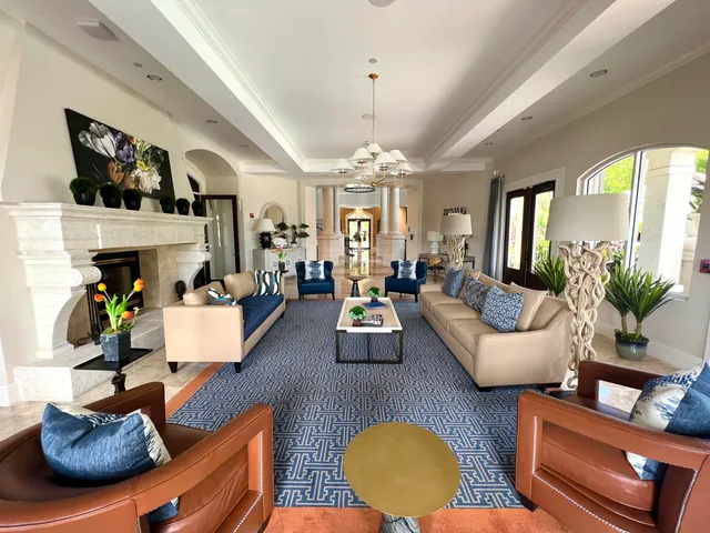 a living room with couches and a dining table with kitchen view