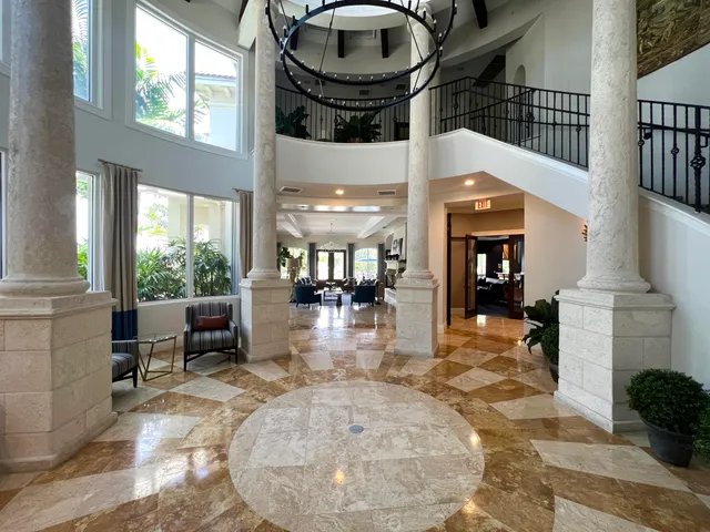 a kitchen with a table chairs and a flat screen tv
