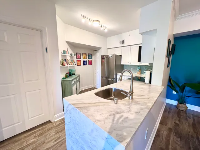a kitchen with sink refrigerator and microwave