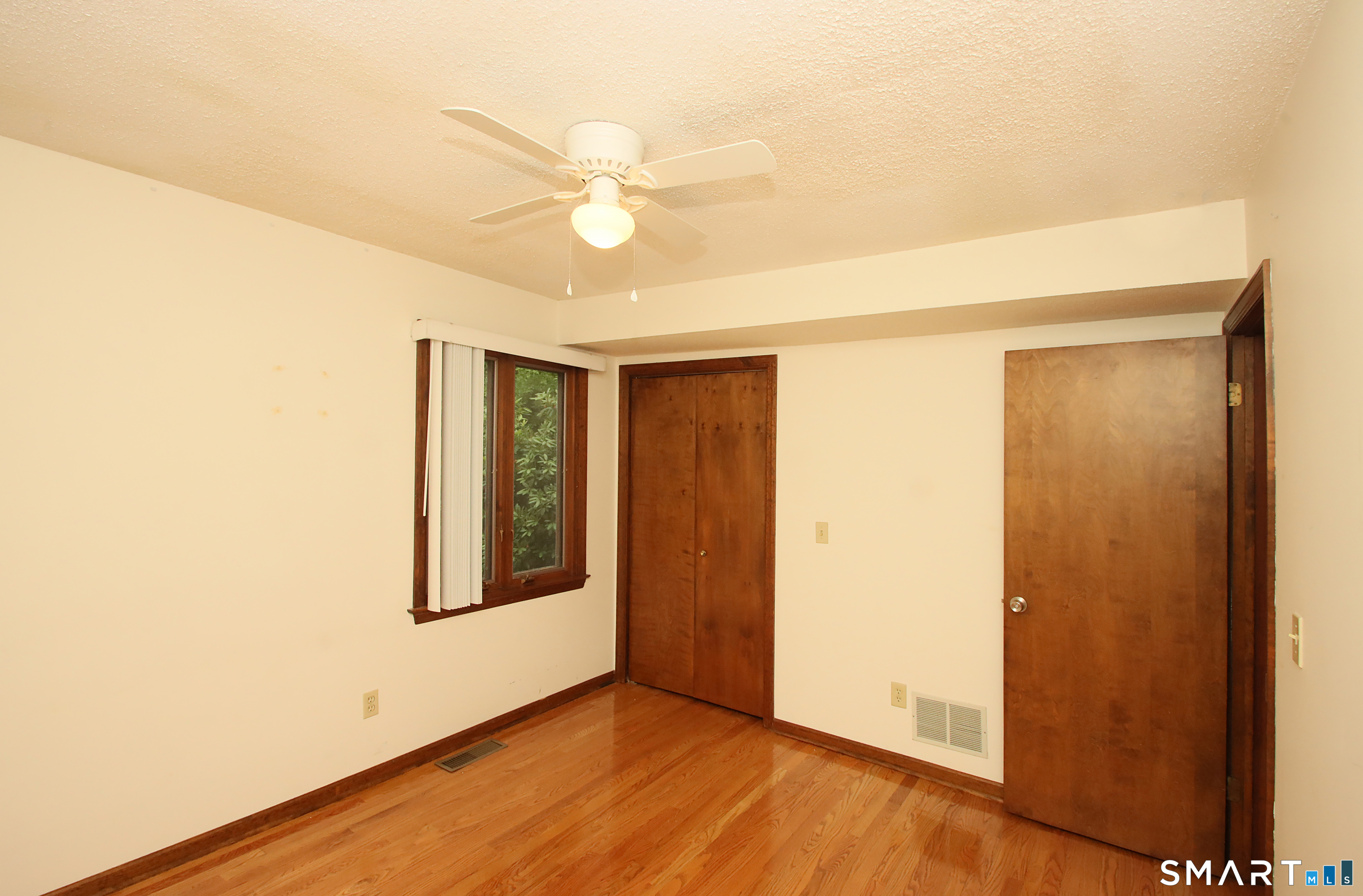 352 Center Street Wolcott, CT 06716 - Photo 27 of 40 a view of an empty room with wooden floor and a ceiling fan