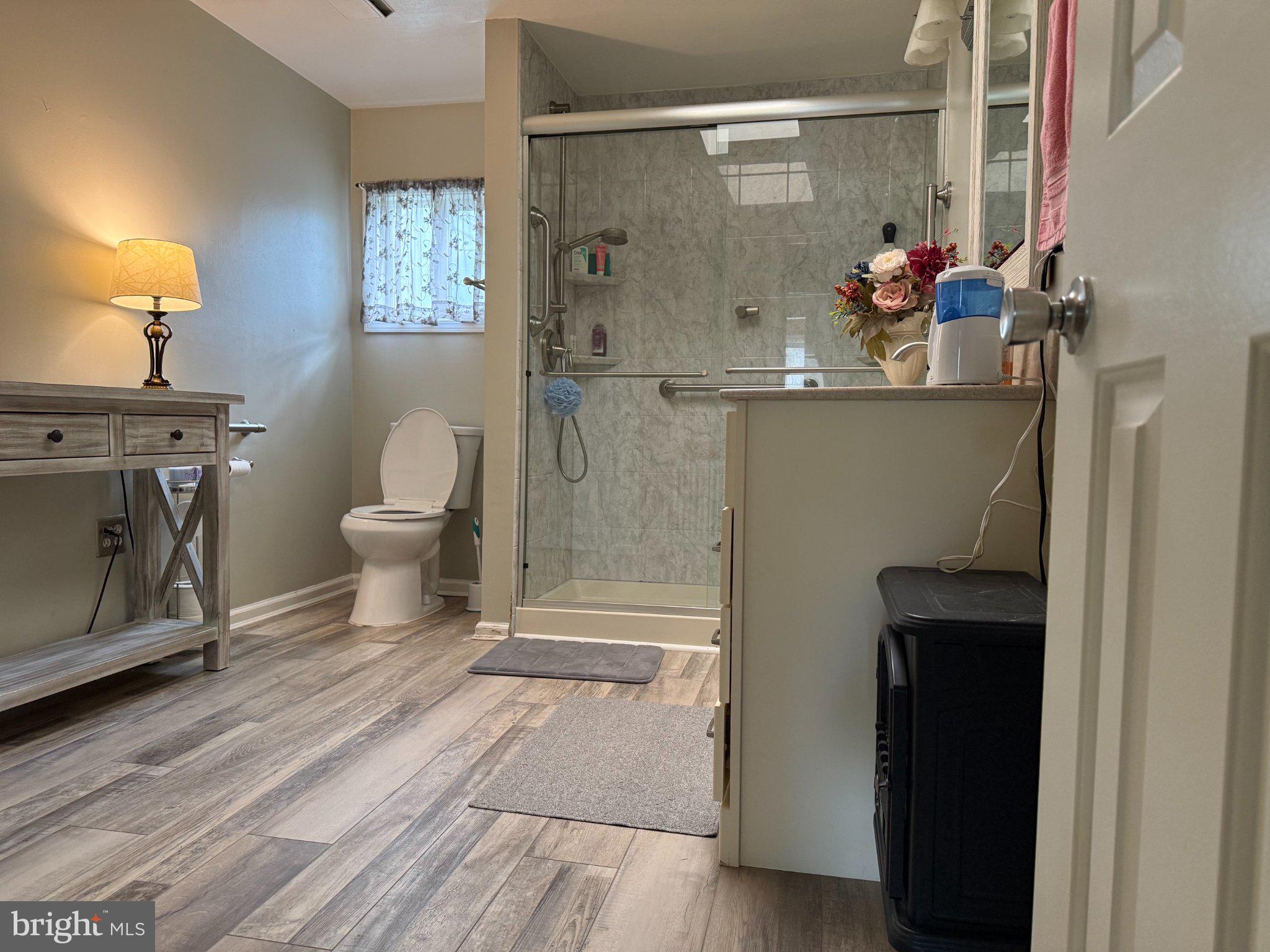 6117 Auth Road Suitland, MD 20746 - Photo 3 of 7 a bathroom with a sink a toilet and shower
