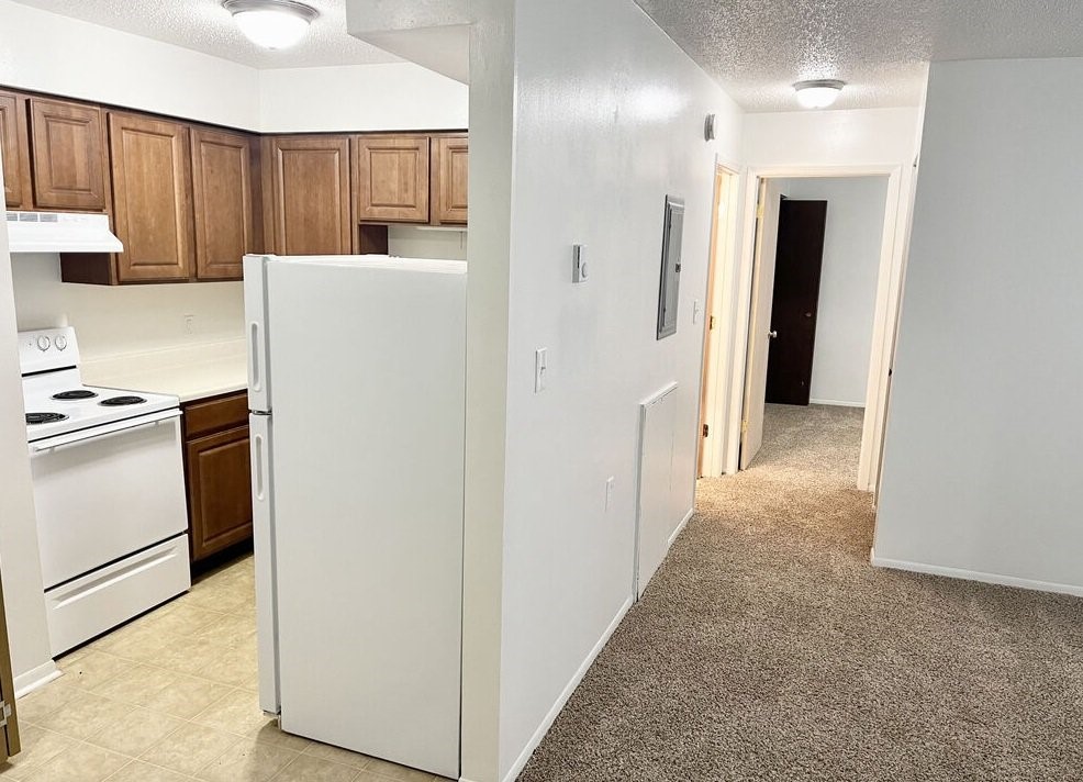 600 John Goodhue Road Carlisle, IA 50047 - Photo 4 of 8 a view of hallway with cabinets and refrigerator