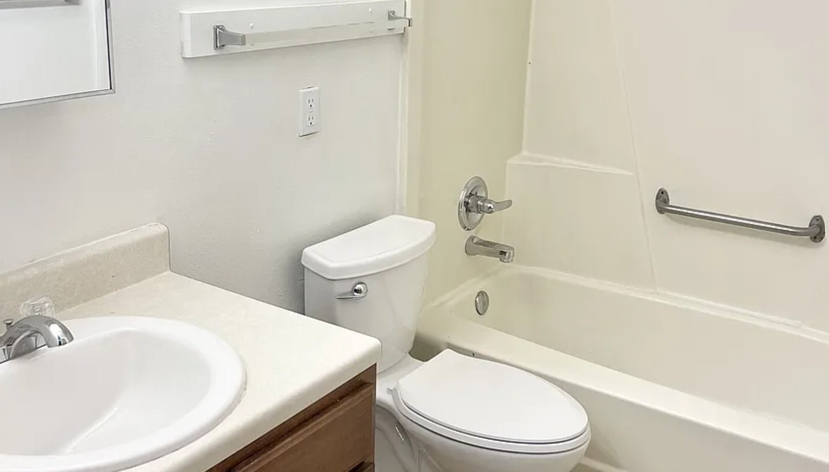 600 John Goodhue Road Carlisle, IA 50047 - Photo 7 of 8 a white toilet sitting next to a bath tub