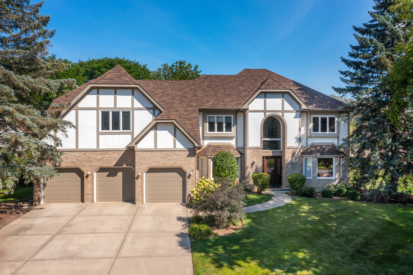 23W250 Hampton Circle Naperville, IL 60540 - Photo 1 of 42 a front view of a house with a yard