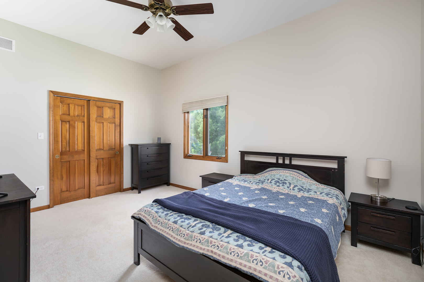 23W250 Hampton Circle Naperville, IL 60540 - Photo 31 of 42 a bedroom with a large bed and a chandelier