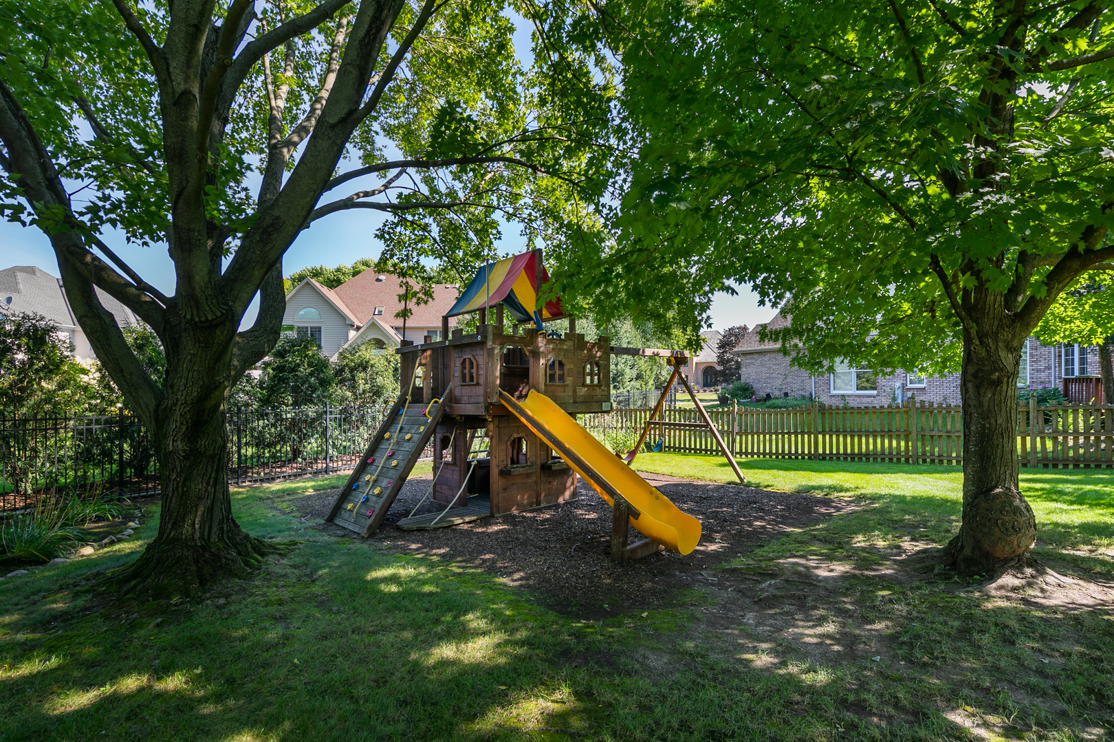23W250 Hampton Circle Naperville, IL 60540 - Photo 4 of 42 a garden with trees and wooden fence