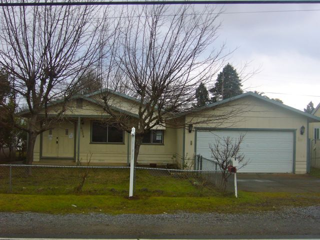 4559 Cedars Road Redding, CA 96001 - Photo 1 of 12 a front view of a house with a yard