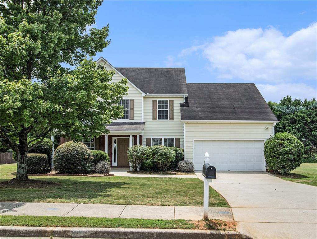 278 Rockingham Drive Loganville, GA 30052 - Photo 1 of 1 a front view of a house with a garden