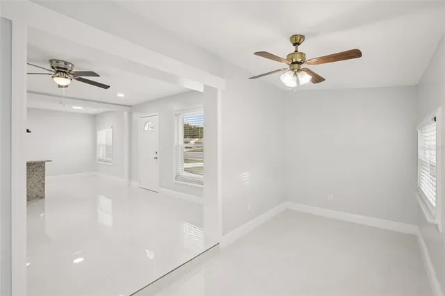 a kitchen with granite countertop kitchen island a table and chairs in it