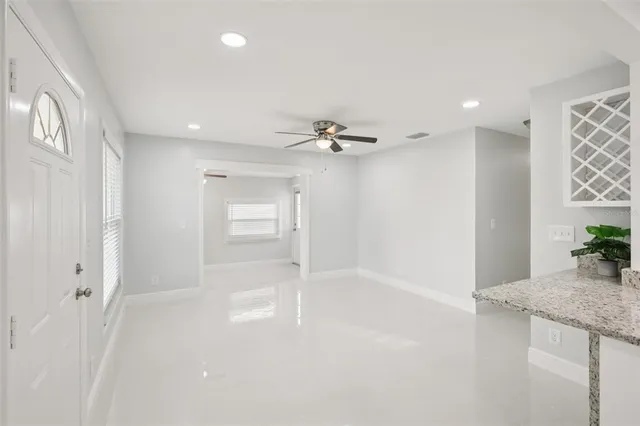 a bathroom with a granite countertop sink a faucet and a shower
