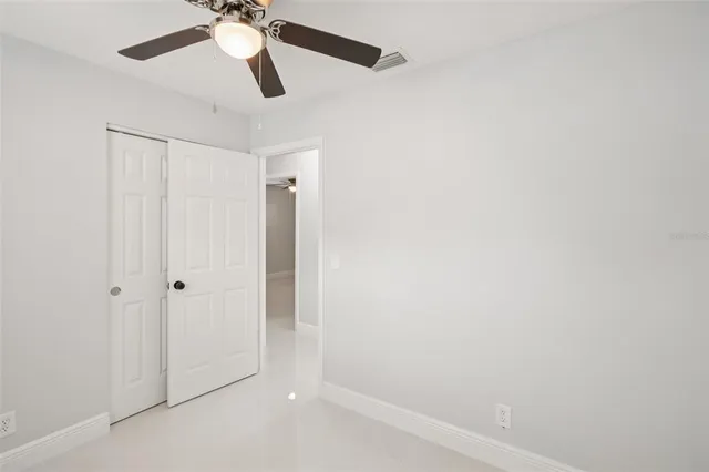 a bedroom with a large bed and a tv