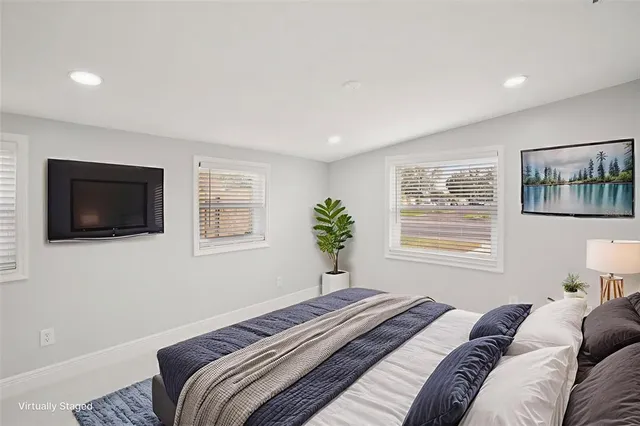 a bedroom with a large bed and a tv