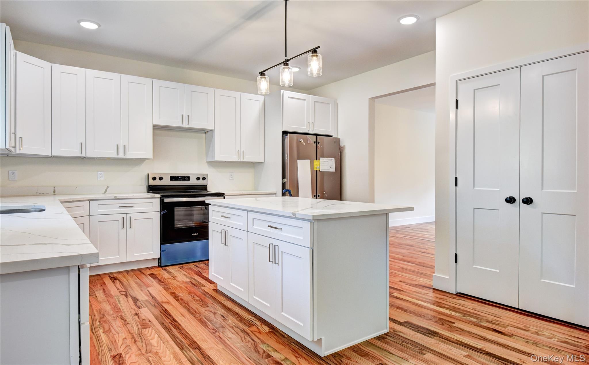 20 Wells Road Newburgh, NY 12550 - Photo 11 of 47 a kitchen with white cabinets and stainless steel appliances