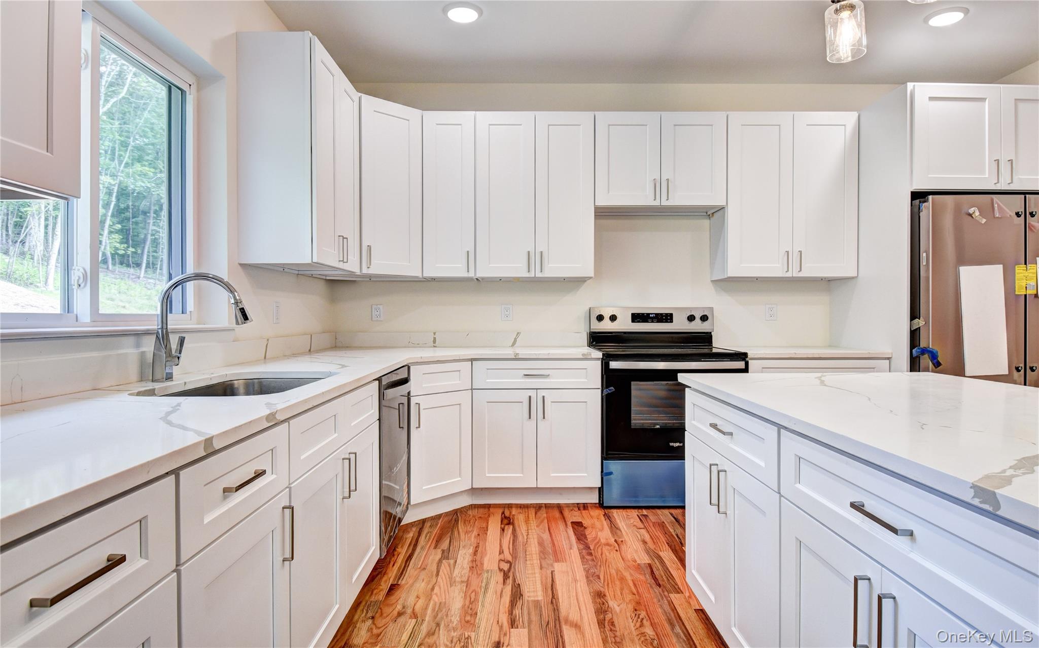20 Wells Road Newburgh, NY 12550 - Photo 12 of 47 a kitchen with cabinets appliances a sink and a window