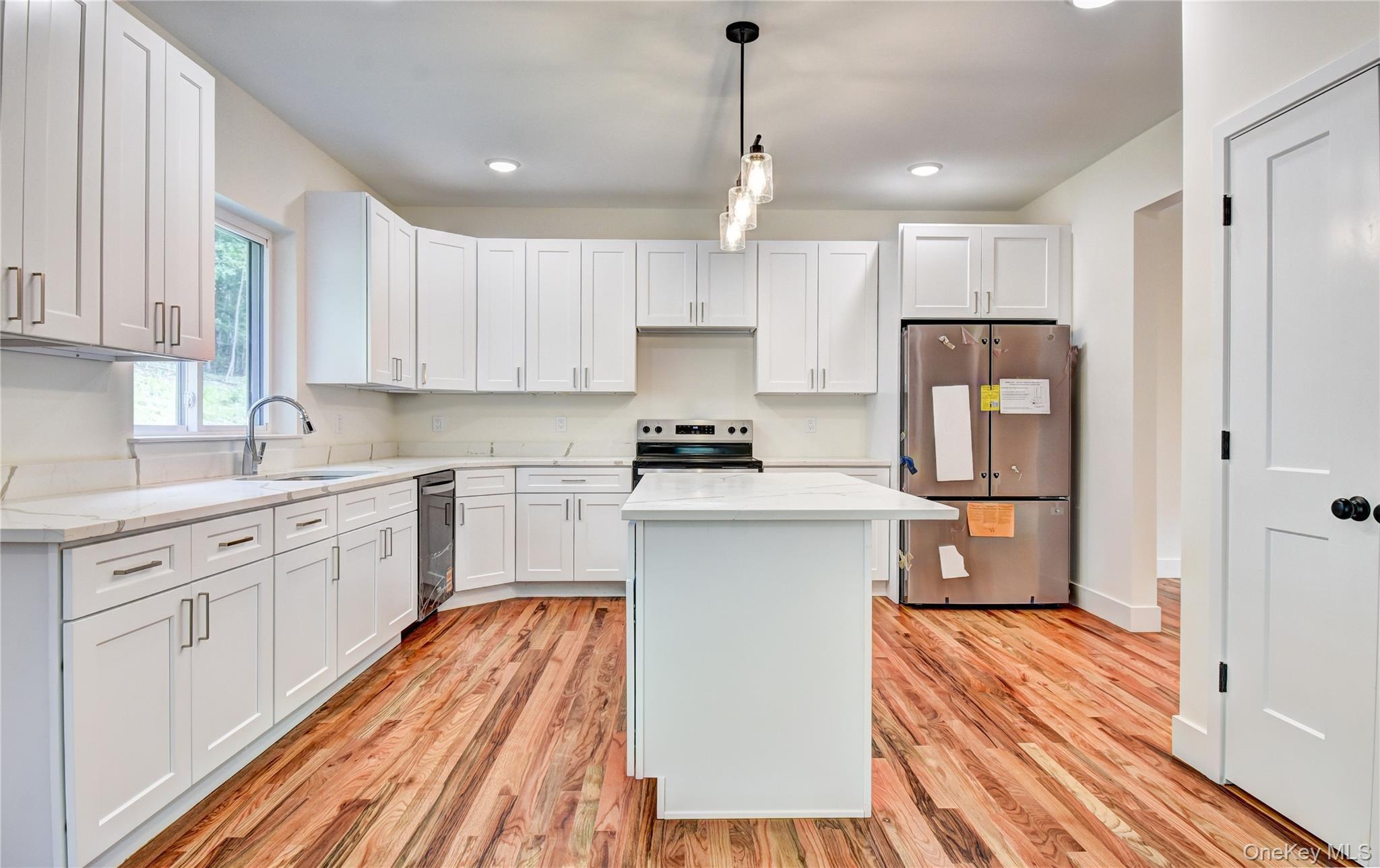 20 Wells Road Newburgh, NY 12550 - Photo 13 of 47 a kitchen with a refrigerator a sink and dishwasher with white cabinets