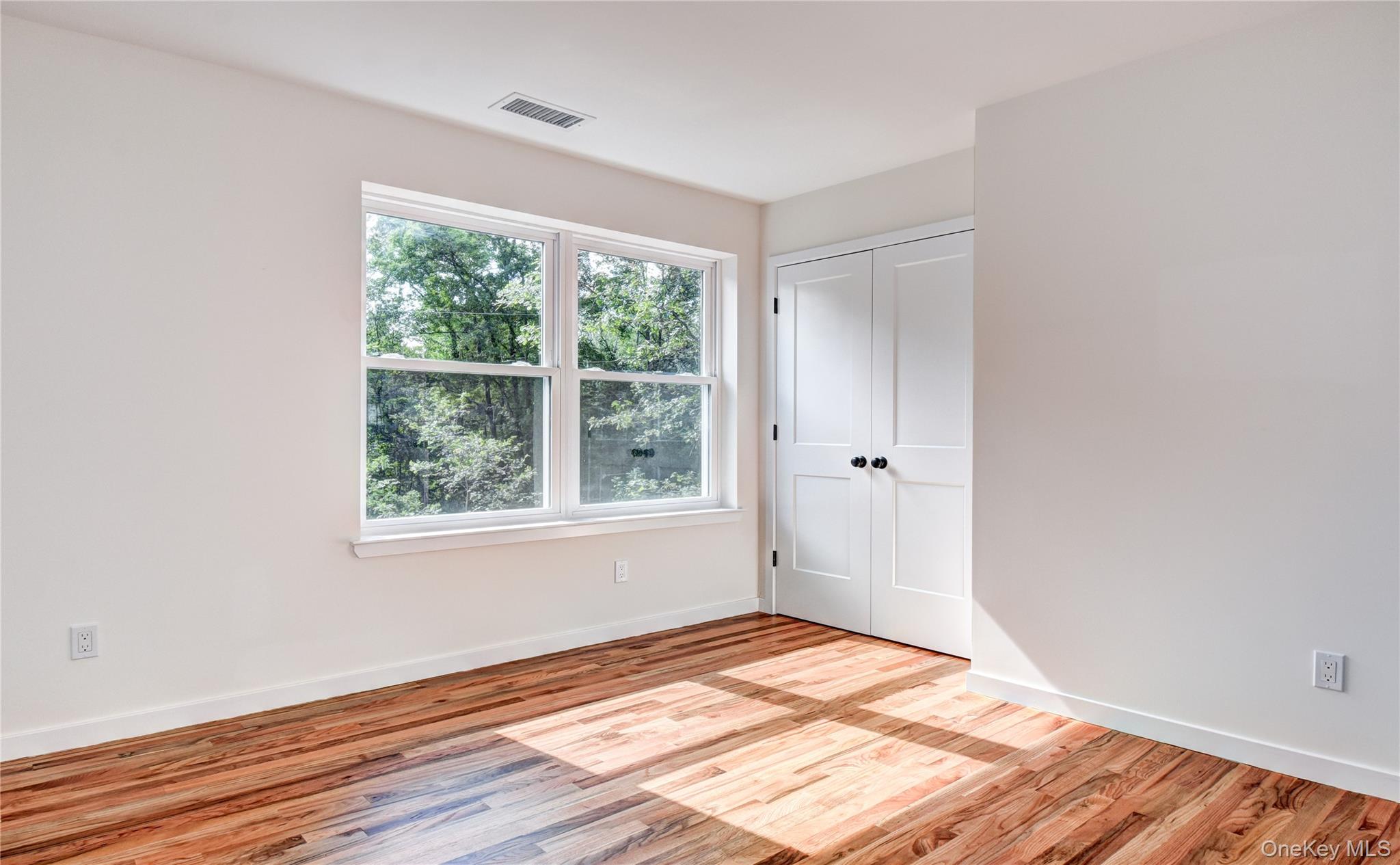 20 Wells Road Newburgh, NY 12550 - Photo 25 of 47 an empty room with wooden floor and windows