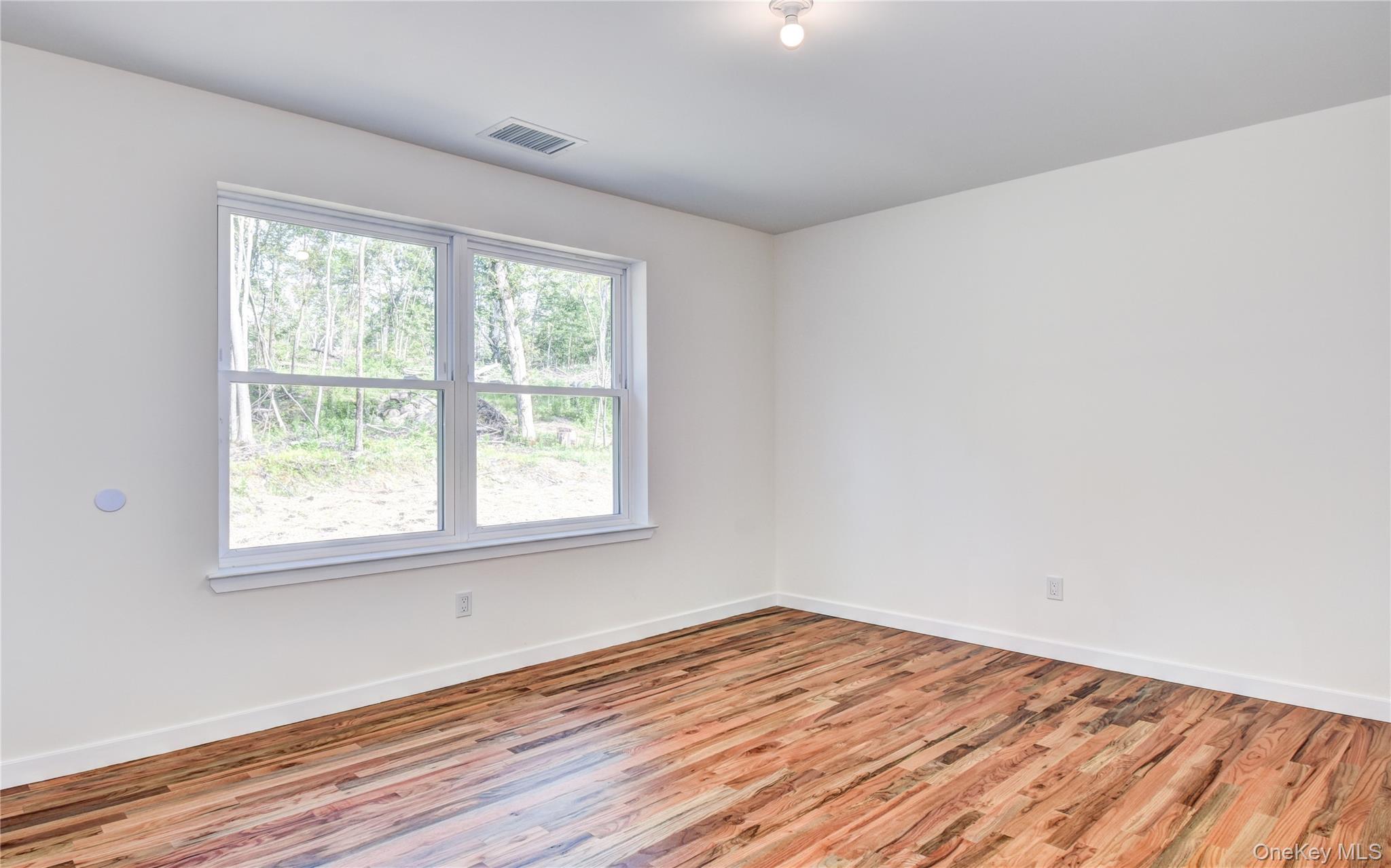 20 Wells Road Newburgh, NY 12550 - Photo 27 of 47 an empty room with wooden floor and windows