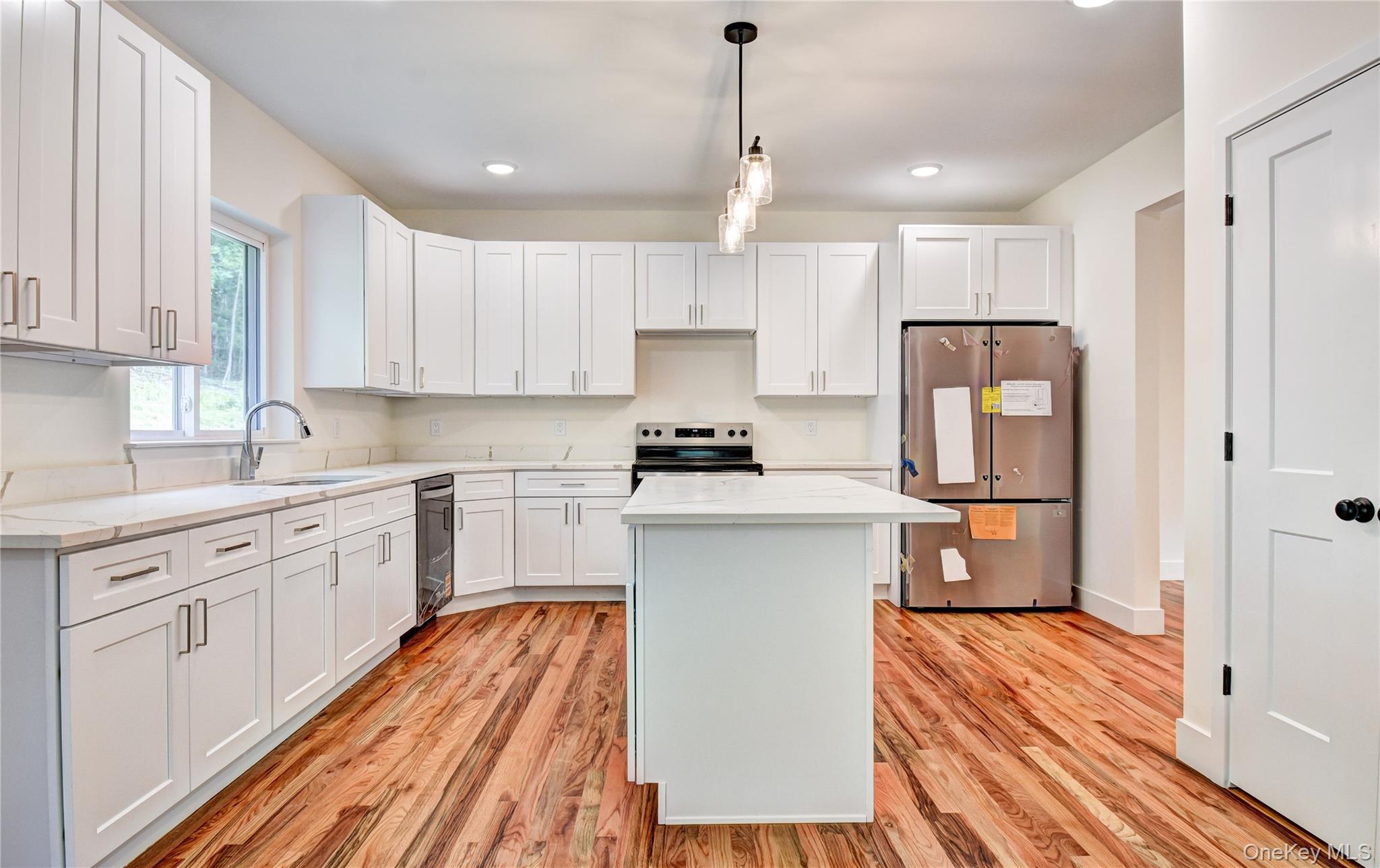 20 Wells Road Newburgh, NY 12550 - Photo 10 of 47 a kitchen with a refrigerator a sink and wooden floors