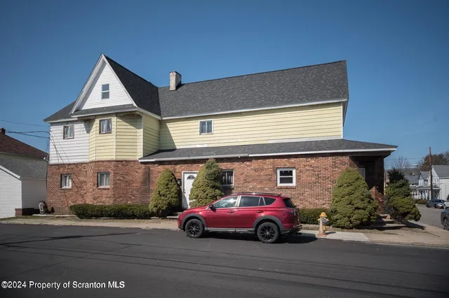 a view of multiple houses with a street