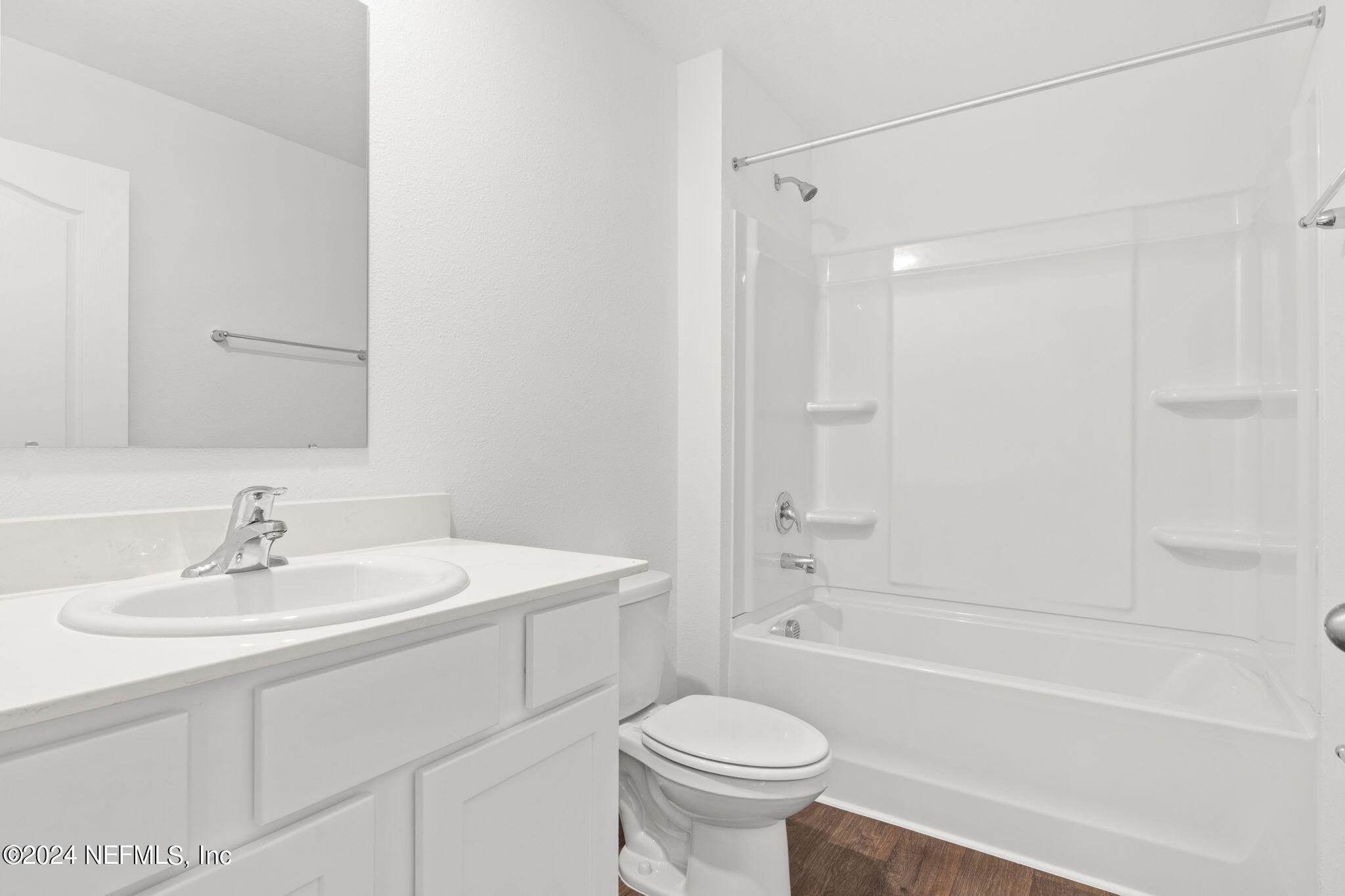 12573 Rubber Fig Terrace Jacksonville, FL 32218 - Photo 17 of 24 a bathroom with a sink toilet a mirror and shower