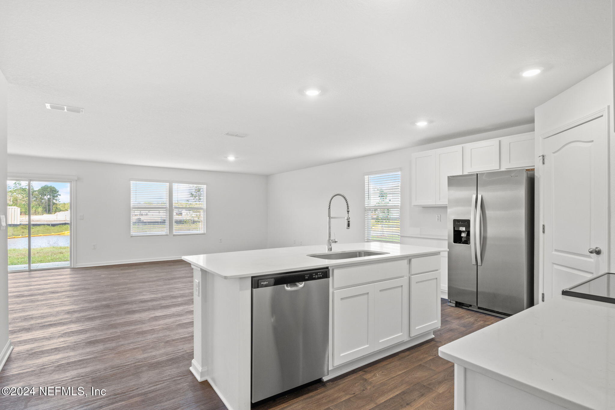 12573 Rubber Fig Terrace Jacksonville, FL 32218 - Photo 4 of 24 a kitchen with stainless steel appliances a sink a refrigerator and a stove