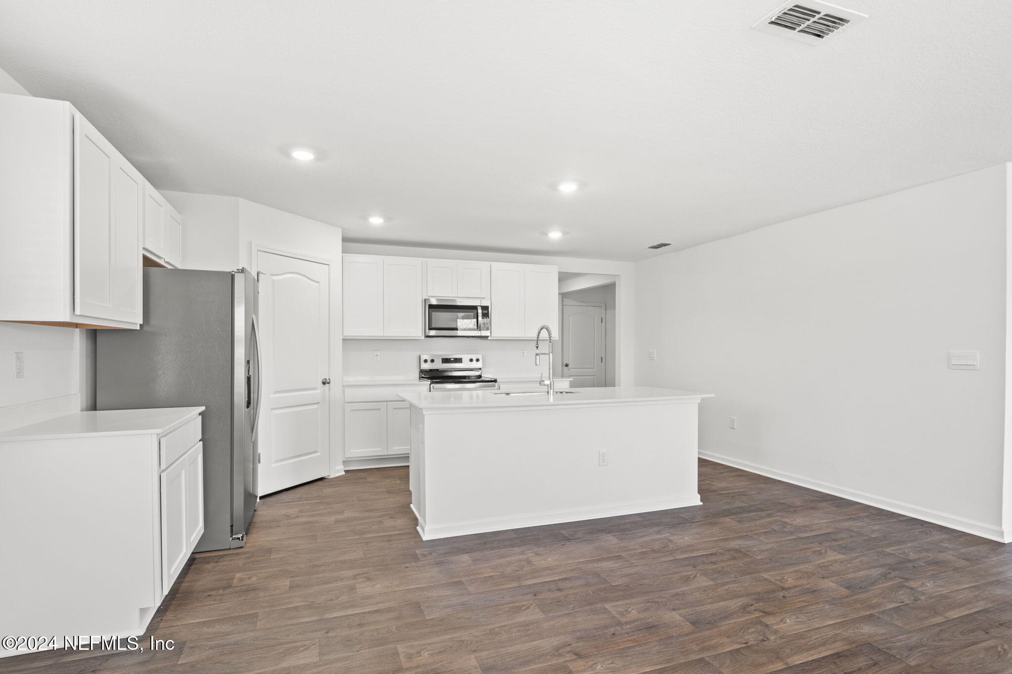 12573 Rubber Fig Terrace Jacksonville, FL 32218 - Photo 6 of 24 a view of kitchen with stainless steel appliances refrigerator stove microwave and cabinets
