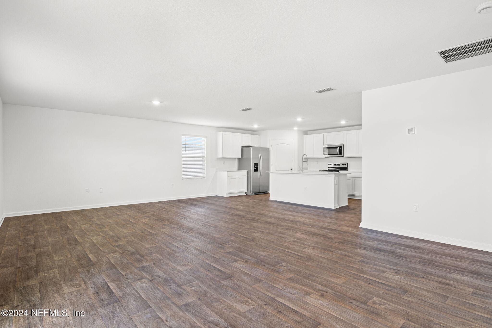 12573 Rubber Fig Terrace Jacksonville, FL 32218 - Photo 9 of 24 a view of a kitchen with a sink and wooden floor