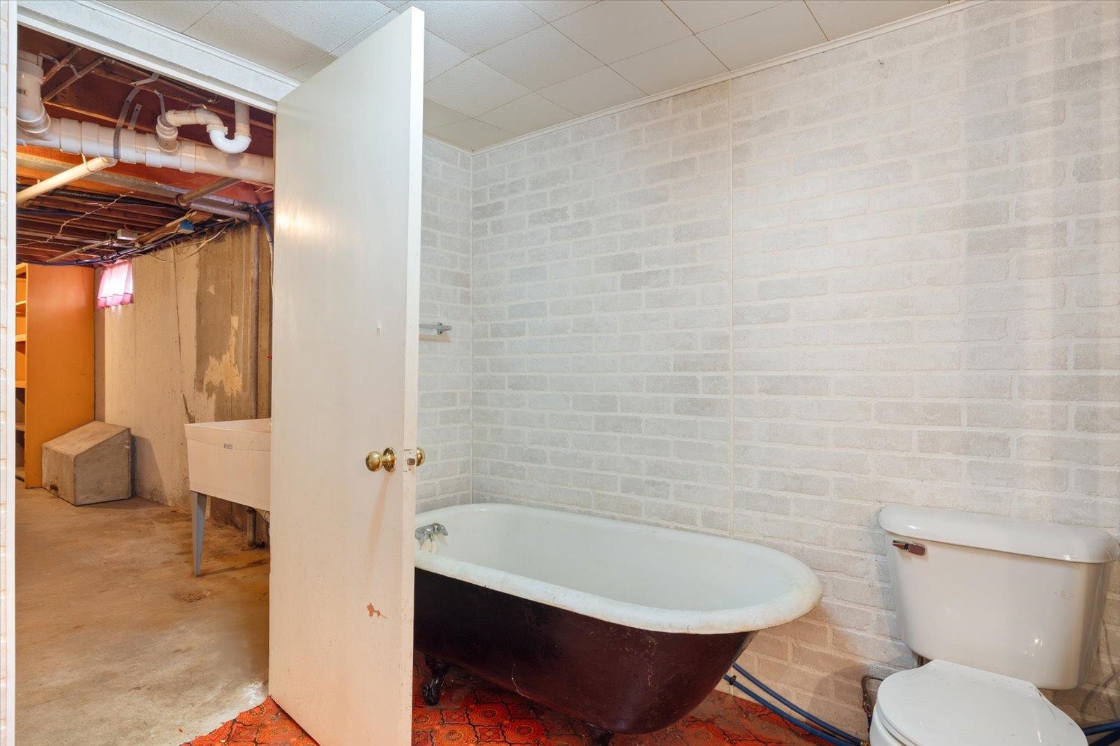 202 Suffolk Drive Hoyt Lakes, MN 55750 - Photo 22 of 33 Full bathroom with a freestanding bath and unfinished concrete flooring