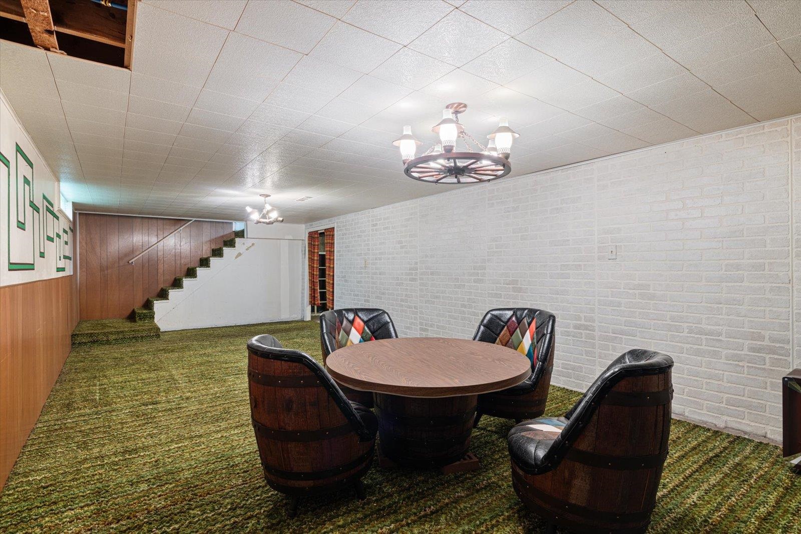 202 Suffolk Drive Hoyt Lakes, MN 55750 - Photo 26 of 33 Dining space featuring a chandelier, stairs, and carpet