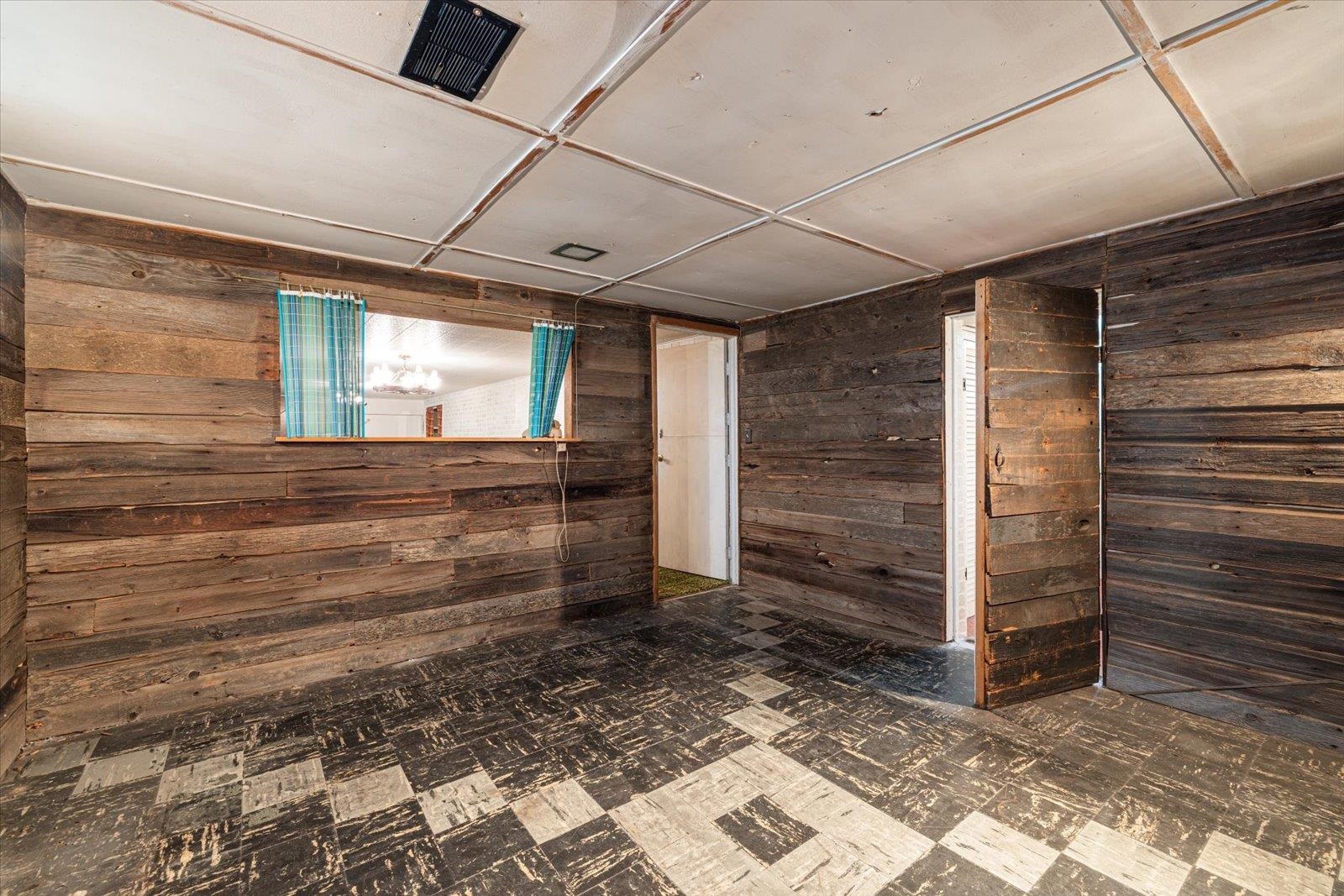 202 Suffolk Drive Hoyt Lakes, MN 55750 - Photo 27 of 33 Spare room with wood walls and dark flooring
