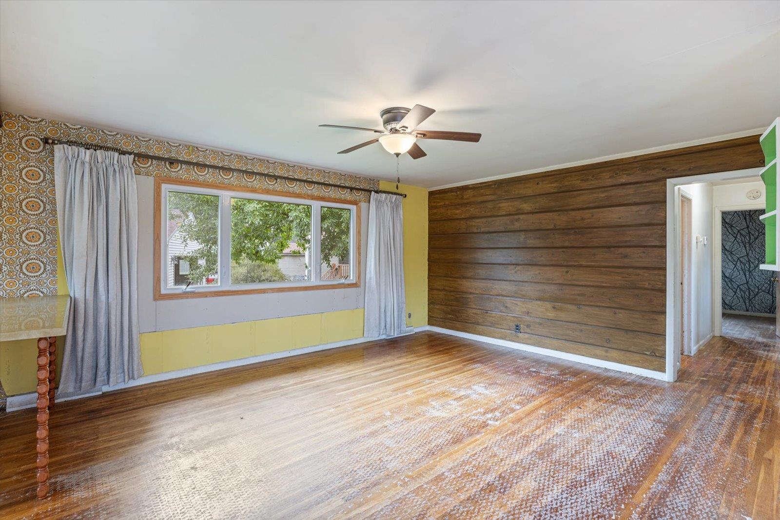 202 Suffolk Drive Hoyt Lakes, MN 55750 - Photo 9 of 33 Spare room featuring a ceiling fan, wood finished floors, and wooden walls