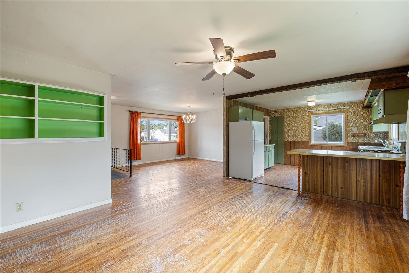 202 Suffolk Drive Hoyt Lakes, MN 55750 - Photo 10 of 33 Kitchen with freestanding refrigerator, wallpapered walls, green cabinets, a chandelier, and light wood-type flooring