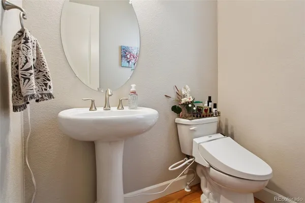 a bathroom with a sink toilet and mirror