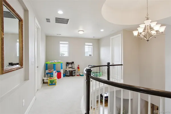 a view of a hallway with a dining table chandelier